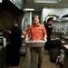 Holiday's Owner Rob TerBush carries a turkey to the oven on Monday. TerBush says they will cook 20 turkeys to be served on Thanksgiving. Daniel Brenner I AnnArbor.com